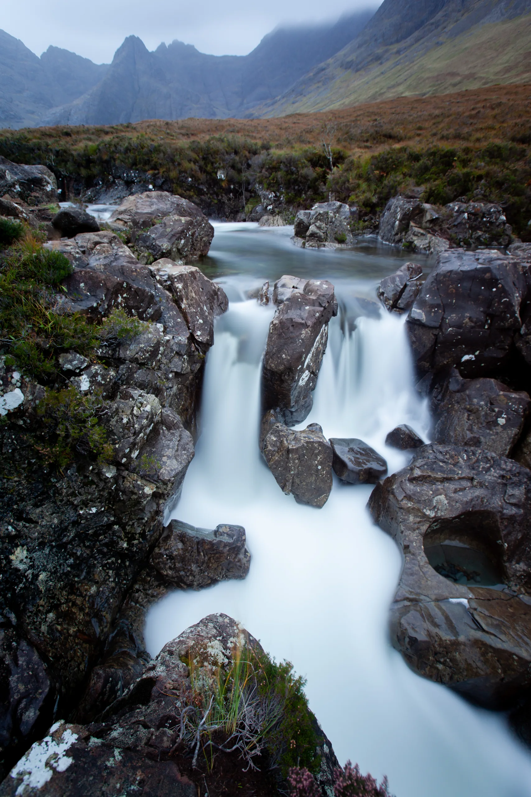 Water cascading through dark rock pools at the Fairy Pools on the Isle of Skye