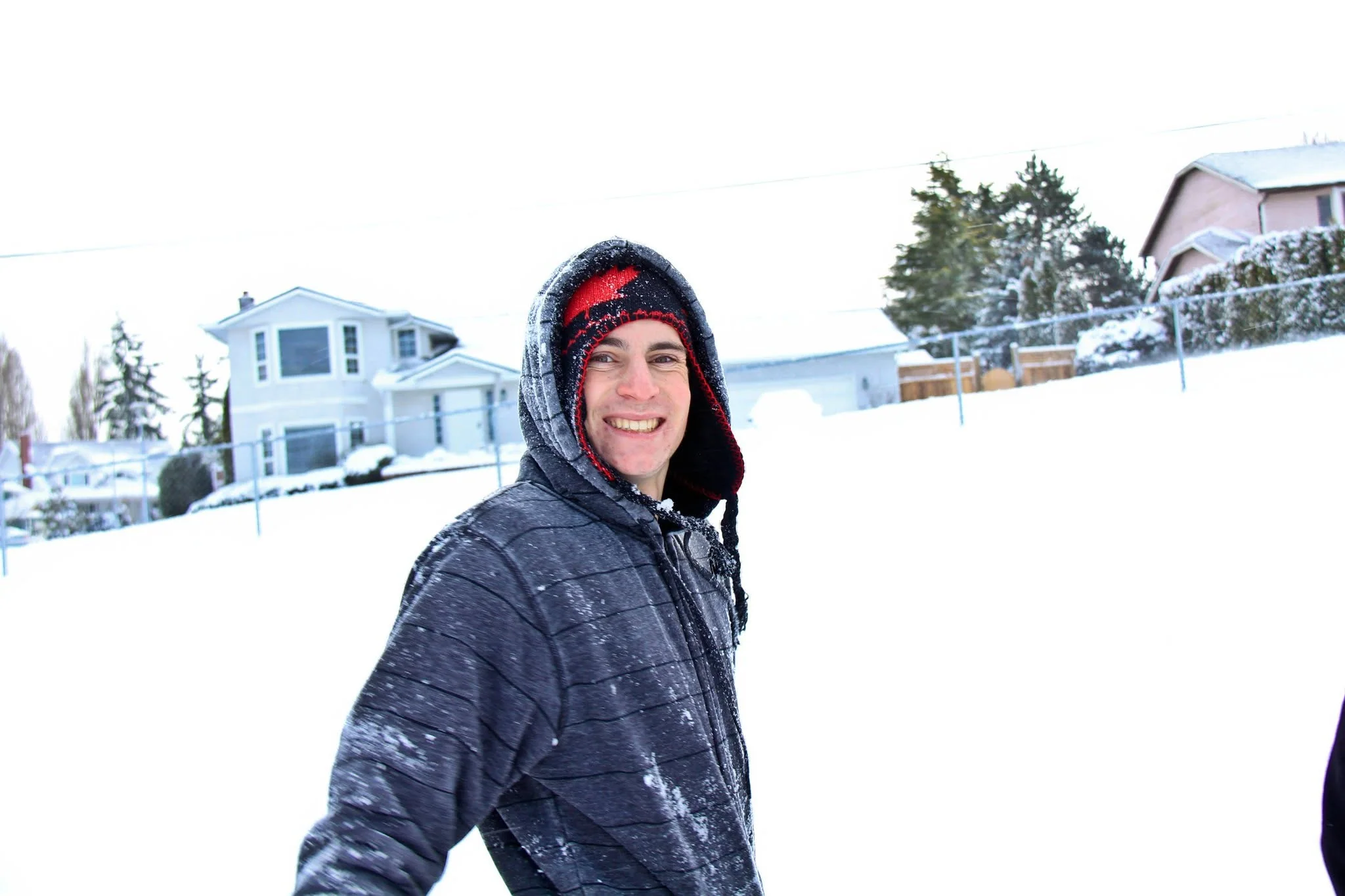 Owen smiling outside during a fresh snowfall at Royal Oak Middle School